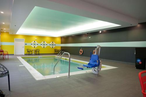 a swimming pool with a chair in a room at Tru By Hilton Chambersburg in Chambersburg
