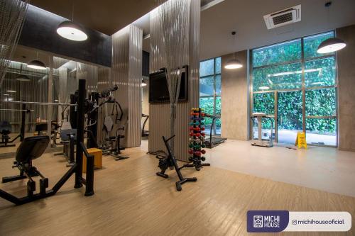a gym with exercise equipment and a large window at MH 10002 - Lindo Studio com WF/AC/Cama Casal in Sao Paulo