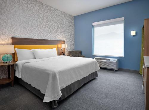 a bedroom with a large bed and a window at Home2 Suites By Hilton Fishers Indianapolis Northeast in Fishers