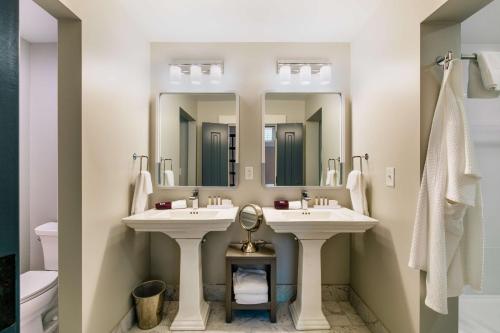 a bathroom with two sinks and two mirrors at Hotel Florence, Tapestry Collection by Hilton in Florence