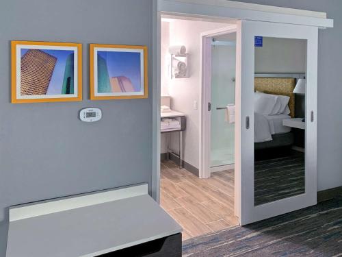 a view of a room with a bed and a mirror at Hampton Inn & Suites Houston East Beltway 8, Tx in Houston