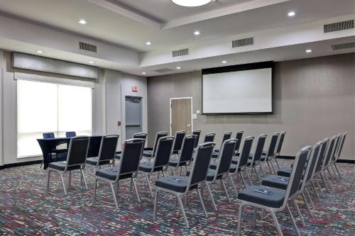 a conference room with chairs and a projection screen at Hampton Inn & Suites Houston East Beltway 8, Tx in Houston