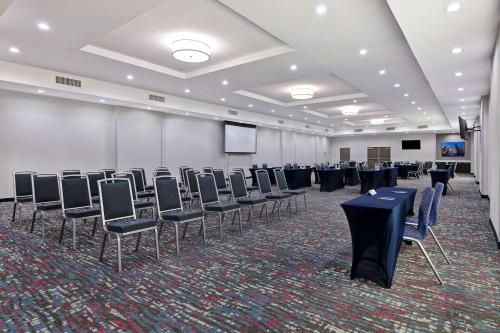 a room with rows of chairs and a screen at Hampton Inn & Suites Houston East Beltway 8, Tx in Houston