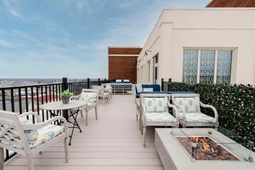 a balcony with chairs and tables and a fire pit at Hotel Elkhart, Tapestry Collection By Hilton in Elkhart