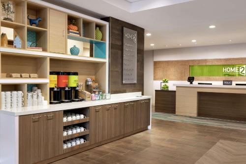 a coffee shop with a counter in a room at Home2 Suites by Hilton New Brunswick, NJ in New Brunswick