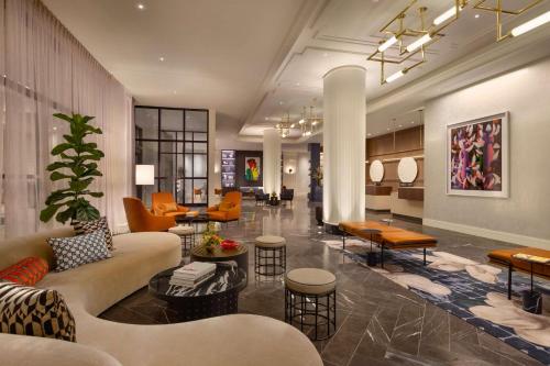 a lobby of a hotel with couches and tables at 106 Jefferson Huntsville, Curio Collection by Hilton in Huntsville