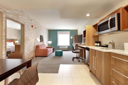 a kitchen and living room in a hotel room at Home2 Suites by Hilton New Brunswick, NJ in New Brunswick