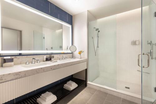 a bathroom with a sink and a shower at 106 Jefferson Huntsville, Curio Collection by Hilton in Huntsville