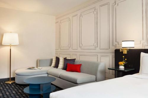 a hotel room with a couch and a bed at 106 Jefferson Huntsville, Curio Collection by Hilton in Huntsville