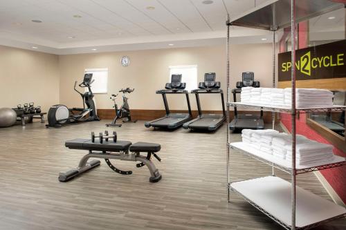 a fitness room with several treadmills and exercise equipment at Home2 Suites by Hilton Fort Myers Airport in Fort Myers