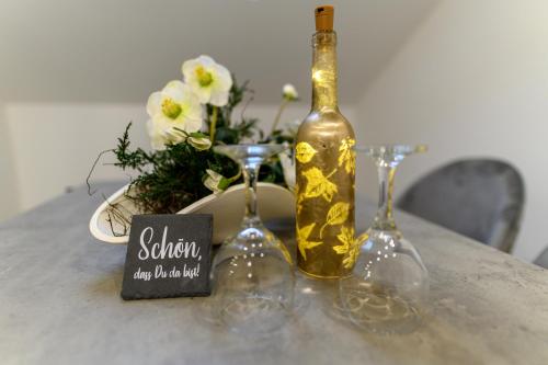 a bottle of wine sitting on a table with wine glasses at Villa Bellevue in Novi Vinodolski