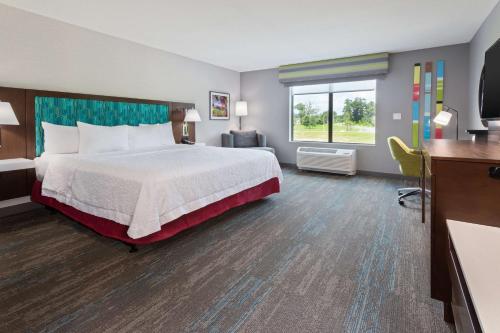 una camera d'albergo con letto e TV di Hampton Inn & Suites Alachua I-75, FL ad Alachua