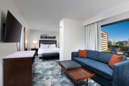 ヒューストンにあるDoubleTree by Hilton Houston Medical Center Hotel & Suitesのソファとベッド付きのホテルルーム
