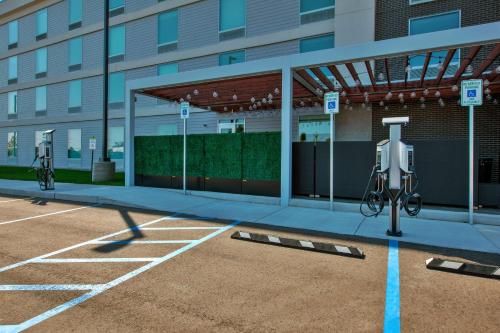 an empty parking lot in front of a building at Home2 Suites By Hilton Grand Rapids South in Byron Center