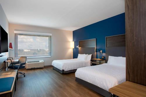 ein Hotelzimmer mit 2 Betten und einem Fenster in der Unterkunft Tru By Hilton Port St Lucie Tradition in Port Saint Lucie