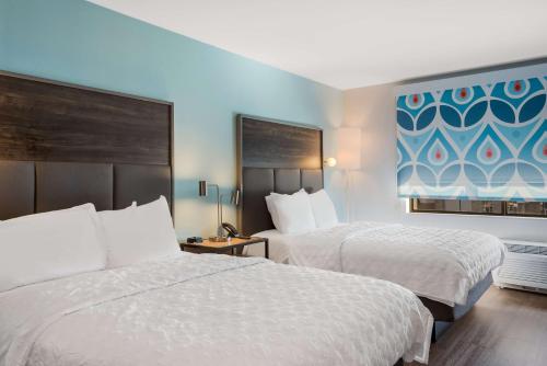 a hotel room with two beds and a window at Tru By Hilton Greensboro, Nc in Greensboro