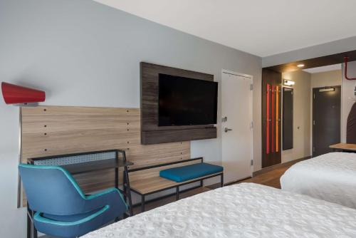a hotel room with two beds and a flat screen tv at Tru By Hilton Greensboro, Nc in Greensboro