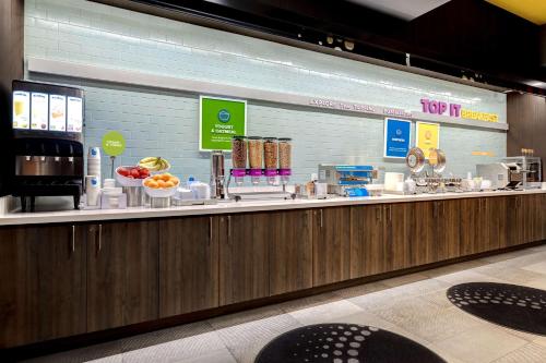 a food counter in a restaurant with food items at Tru By Hilton Galveston, Tx in Galveston
