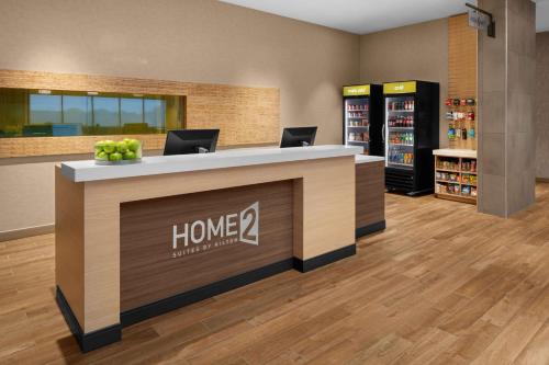 a store lobby with two laptops on a counter at Home2 Suites By Hilton Hobbs in Hobbs