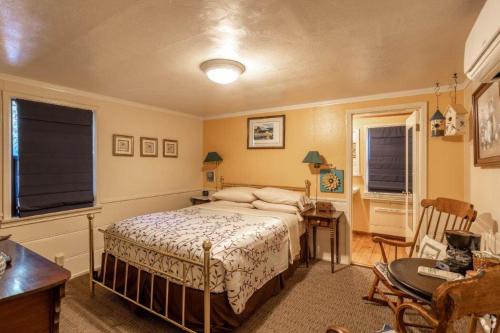 a bedroom with a bed and a table and chairs at Idyllwild Inn in Idyllwild