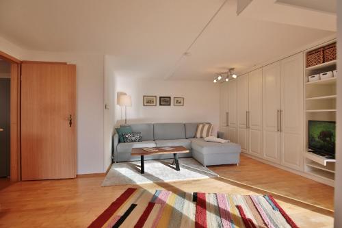 a living room with a couch and a table at Ferienhaus Aalweg in Niendorf
