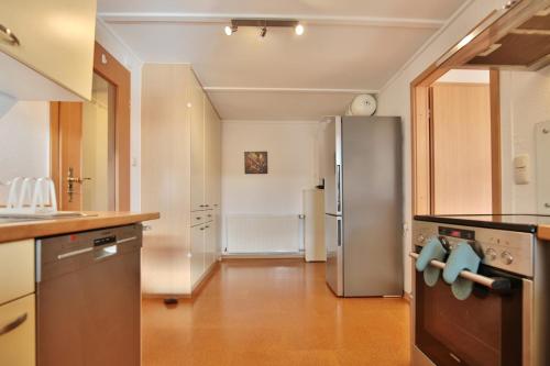 a kitchen with a stainless steel refrigerator at Ferienhaus Aalweg in Niendorf