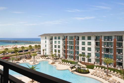 a view of a resort with a pool and the beach at Embassy Suites By Hilton Panama City Beach Resort in Panama City Beach