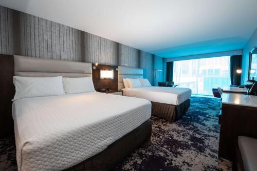 a hotel room with two beds and a window at DoubleTree by Hilton Houston Brookhollow in Houston
