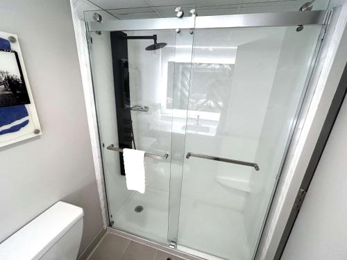 a glass shower in a bathroom with a toilet at Best Western Plus Heritage Rail Inn & Suites in York