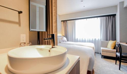 a bathroom with a sink in a hotel room at Best Western Plus Nagoya Sakae in Nagoya
