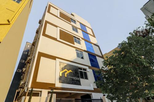 a building with a picture of a yellow arrow in the window at Super OYO Flagship Landcorp Hotels in Kondapur