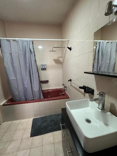a bathroom with a sink and a tub with a shower at Santa Madre B&B in San Luis Potosí