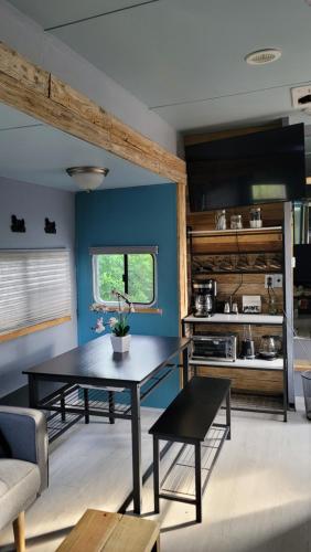 a living room with a table and a blue wall at Shroom life farm Chicken shack in North Fort Myers