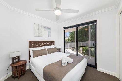 a bedroom with a bed and a large window at Tomaree Road 16 in Shoal Bay