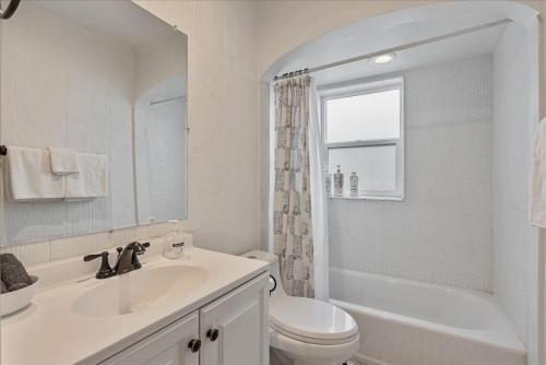 a white bathroom with a sink and a toilet at Located in the heart of Provo Right off i15 in Provo
