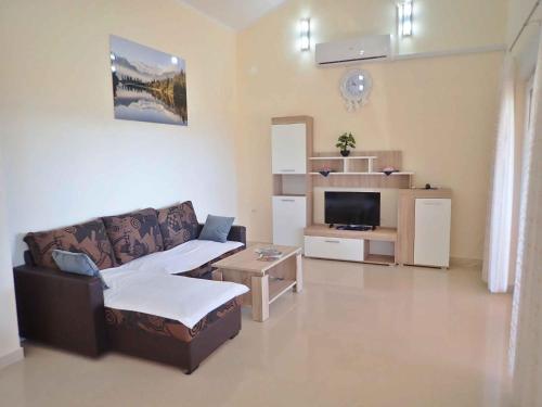 a living room with a couch and a table at Apartment in Starigrad-Paklenica 38616 in Starigrad