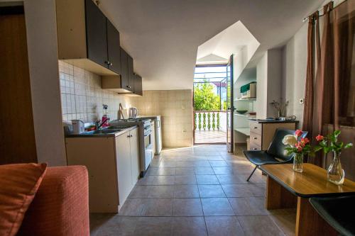 a kitchen with a counter and a table and a kitchen with at Apartment in Starigrad-Paklenica 6879 in Starigrad