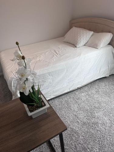 um quarto com uma cama com uma mesa de centro com flores em Home away from Home em Manvel