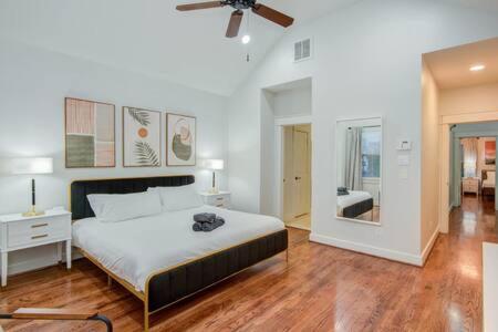 a bedroom with a large bed with a ceiling fan at Luxury Houston Pool and spa Sleeps 10 in Houston