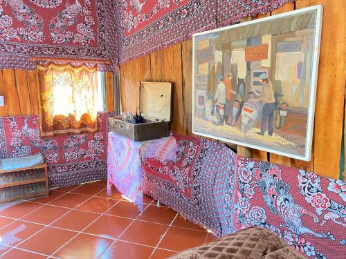 a living room with red walls and red tiles at COI NGUON FARM GLAM Mang Den in Kon Von Kla