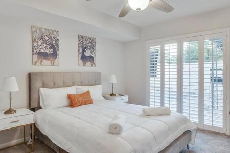 - une chambre blanche avec un grand lit et une fenêtre dans l'établissement West Irving Palace Miami Style, à Irving