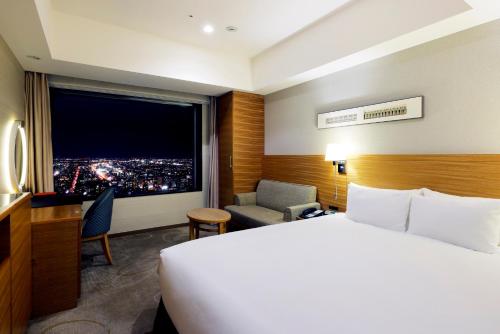 Cama ou camas em um quarto em JR Tower Hotel Nikko Sapporo