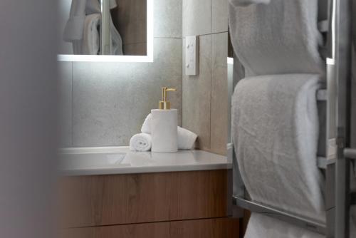 a bathroom with a sink and a mirror at Urban Locale in Christchurch