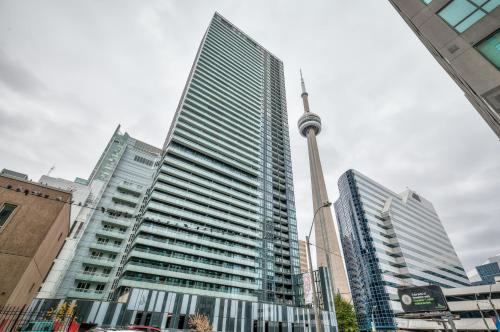 a view of the cn tower in a city at RivetStays - The Atmos in Toronto