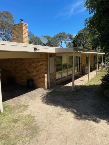 a brick house with a conservatory on top of it at Beauna Vista Rye Retreat Home in Rye