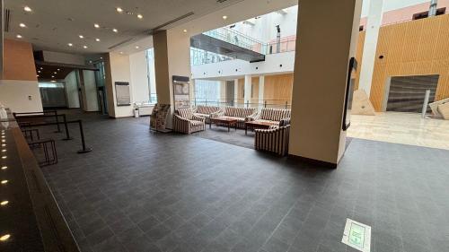an empty lobby with chairs and tables in a building at Chateraise Hotel Nagano in Nagano