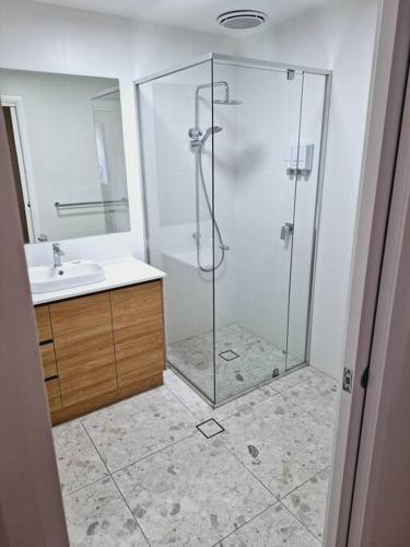 a bathroom with a shower and a sink at Neddidge Apartment 3 in Albury