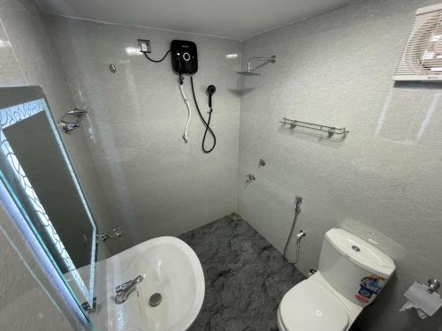 a bathroom with a toilet and a camera on the wall at Happy villa (tuvaraga) 
