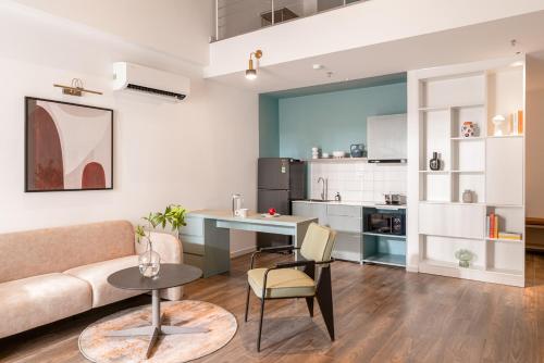 a living room with a couch and a table at M Village Living Kỳ Đồng in Ho Chi Minh City
