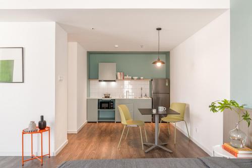 a kitchen and dining room with a table and chairs at M Village Living Kỳ Đồng in Ho Chi Minh City